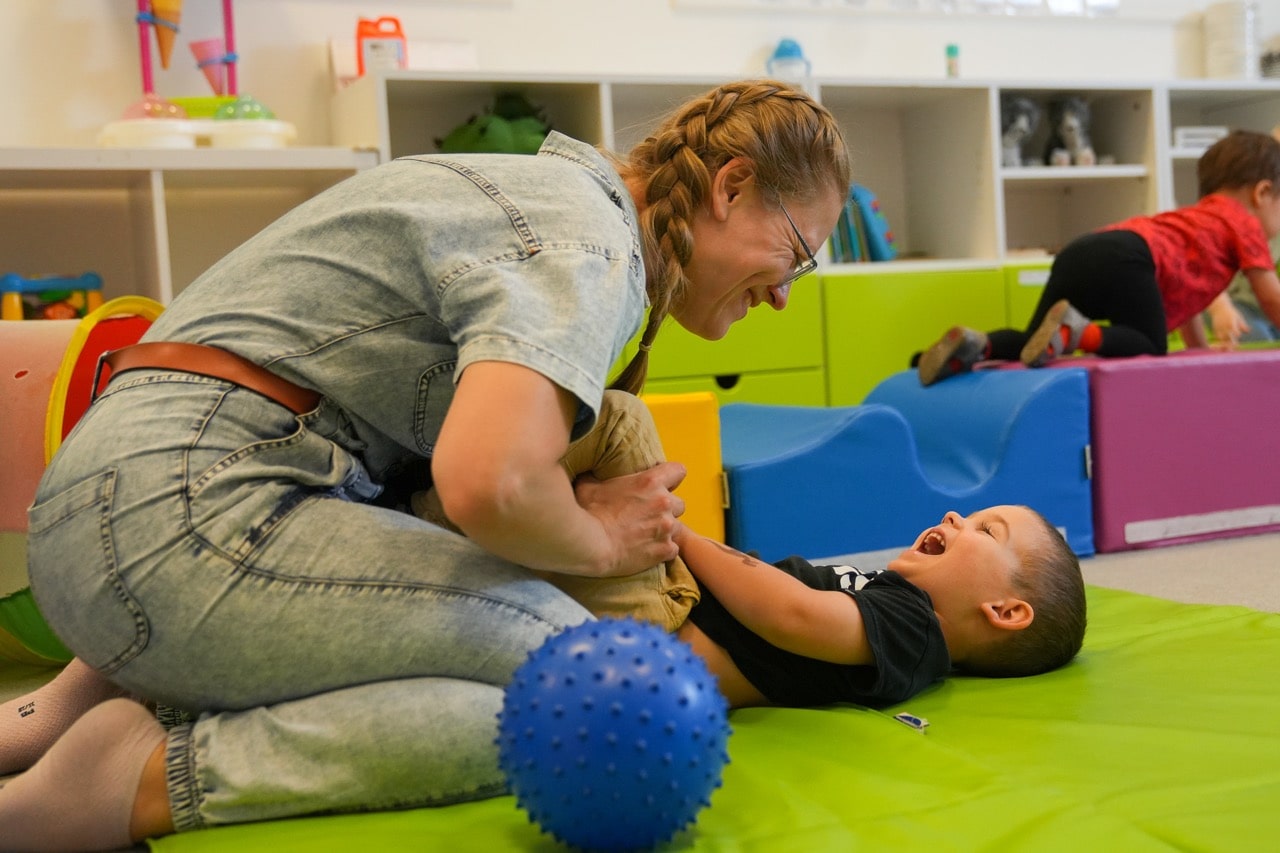 Boy and lady kindergarten center teacher